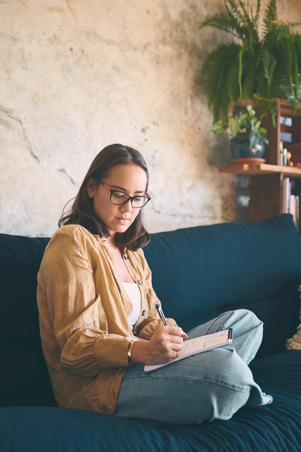 Woman writing in a journal, engaged in personal reflection