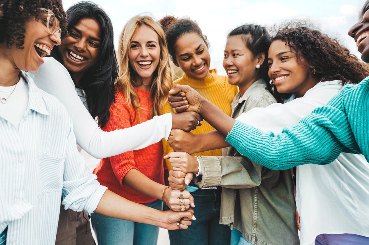 A multicultural community of women standing together in mutual support and strength