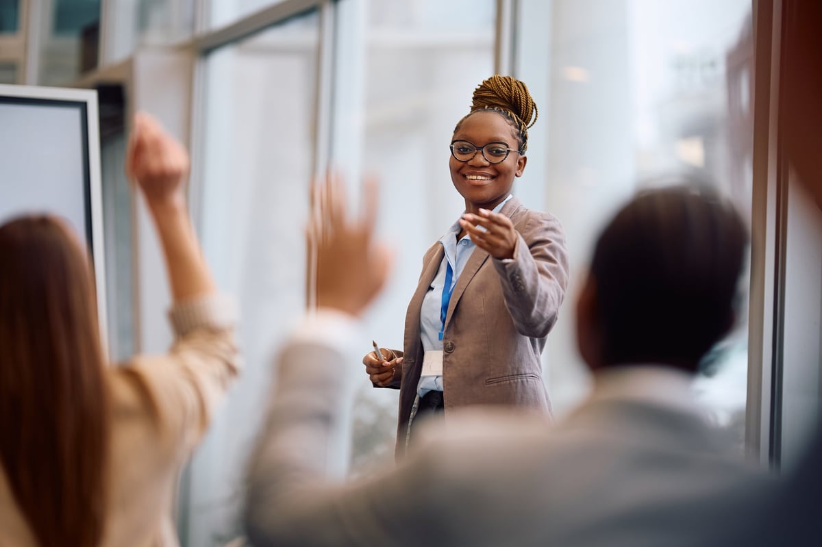 A woman offering guidance to a peer across a boardroom table, the ethos of a small circle rebuilding together