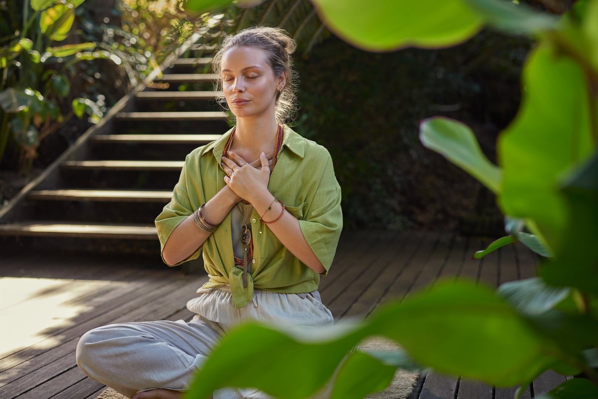 Woman in a peaceful, heart-centered moment of reflection and healing