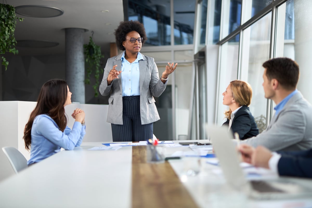 A confident woman of color leading her team with purpose